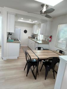 a kitchen and dining room with a wooden table and chairs at Oceanside Getaway at Tuscan Village Condominiums in Oceanside