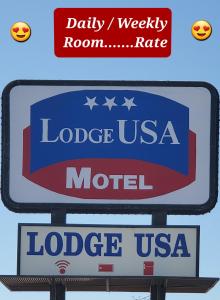 - un panneau indiquant la destination et un motel dans l'établissement Lodge USA Motel, à Guymon