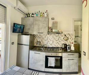 a kitchen with a stove and a refrigerator at Casa di Bea in Ventimiglia
