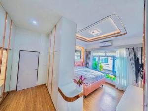 a bedroom with a bed and a large window at Luxury Entire House short term rent In Buriram City for SongKran Festival in Buriram