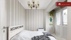 a bedroom with a bed and a chandelier at Teras Residence in Tallinn