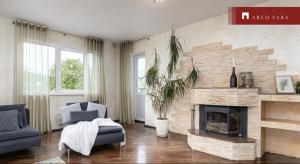 a living room with a fireplace and a blue couch at Teras Residence in Tallinn