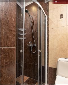 a shower with a glass door in a bathroom at Teras Residence in Tallinn