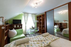 a bedroom with a bed and a table in it at Balaton Fantasy Villa in Balatonfüred