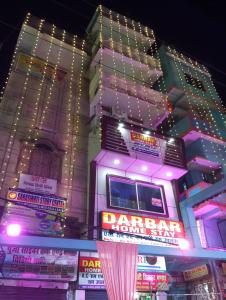 a building with neon signs in front of it at Darbar Homestay in Gaya
