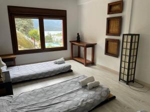 a room with two beds and a window at Picos Pardos CRA-AV-1088 in El Barraco