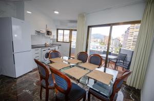 a kitchen and dining room with a table and chairs at SAN JAIME Centro Levante in Benidorm