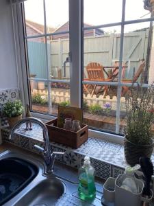 a kitchen counter with a sink and a window at Cosy cottage in Chard