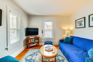 a living room with a blue couch and a table at Anias Retreat with Deck Walk to Lake Michigan! in Two Rivers