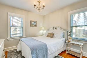 a bedroom with a bed and two windows at Anias Retreat with Deck Walk to Lake Michigan! in Two Rivers