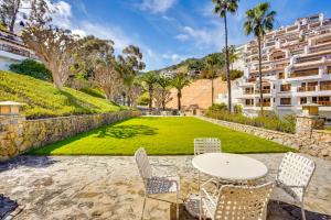 a table and chairs in front of a lawn with buildings at Gorgeous Catalina Island Condo with Golf Cart! in Avalon