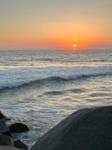 a sunset over the ocean with the sun setting at Oceanside Getaway in Oceanside