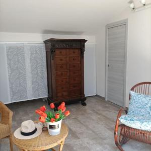 um quarto com uma mesa com flores e uma cómoda em The Bays - La Mansarda ad un passo dal mare em Acireale
