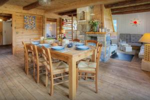 a dining room with a wooden table and chairs at Chalet Arsene et Lea - OVO Network in Manigod