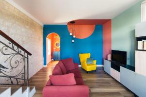 a living room with a red couch and a yellow chair at Villa - La Formica Gentile - Monopoli in Gorgofreddo