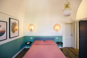 a bedroom with a bed and two stools at Villa - La Formica Gentile - Monopoli in Gorgofreddo