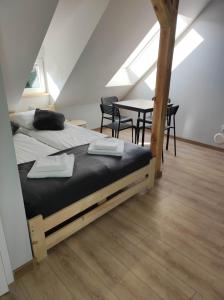 a bedroom with a bed and a table with chairs at Nowe Apartamenty na Światowida VITO APARTMENTS in Międzyzdroje