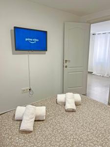 a bedroom with two pillows and a tv on the wall at Reformado. Plaza de Toros. A/C in Alicante