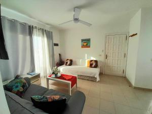 een woonkamer met een bed en een bank bij Apartment Vincent, cozy and sunny over the rooftops in Puerto del Carmen