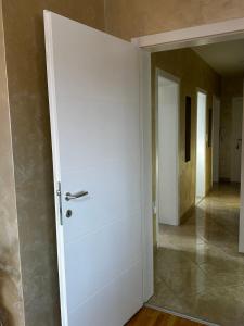 a white door in a room with a hallway at L&D apartman in Kruševac