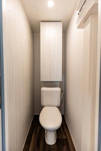 uma casa de banho com um WC branco num quarto em Coco Sweet em Warmond