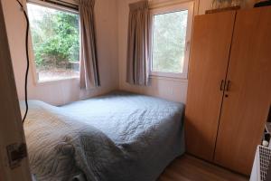 Ένα ή περισσότερα κρεβάτια σε δωμάτιο στο Vakantiehuis De Veldhoen vrijgelegen nabij de rivier de Vecht