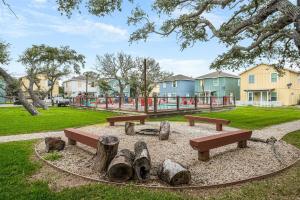 a park with benches and a playground in the background at The Yellow Getaway - Community Pool in Rockport