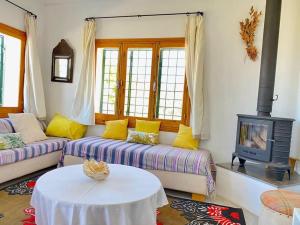 a living room with a couch and a stove at Dar Brahim, Cap Zbib , Vue sur mer in Al Matlīn