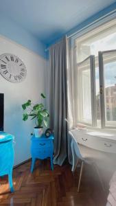 a room with a clock and a table with a plant at Apartment with spacious terrace Villa Floramy in Opatija