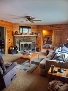 a living room with a couch and a fireplace at Harmony in the Woods in Lake Harmony