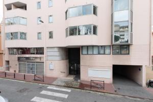 an apartment building on the corner of a street at Le Coquillage - 200 mètres de la Plage in Cannes