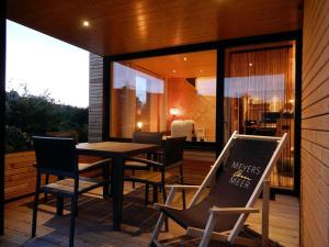 a patio with a table and chairs on a deck at Holiday apartment in Thuringia in Zierow