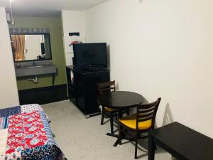 a living room with a table and a television at Suite With Pool Access in Davenport