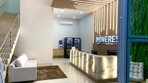 a lobby with a waiting room with couches and a staircase at NERES HOTEL in Xinguara