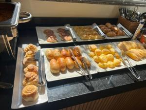 a display case with different types of donuts and pastries at NERES HOTEL in Xinguara