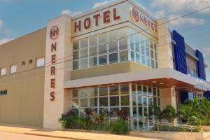 a hotel with a sign on the side of it at NERES HOTEL in Xinguara