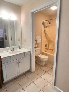 a bathroom with a sink and a toilet and a shower at The Park at Foxborough in Branson