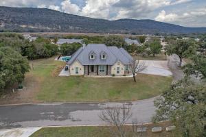 an aerial view of a house with a driveway at Driftwood in Concan