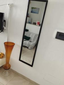 a mirror on a wall in a living room at Appartement num3 Carthage byrsa in Douar ech Chott