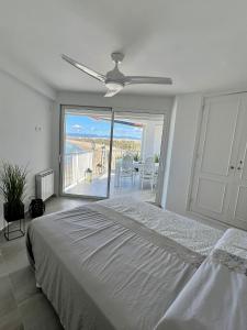a bedroom with a bed and a ceiling fan at Bello Horizonte Apartman 4B in Salou +30 photos