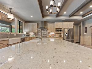 a large kitchen with a large marble counter top at She's Like Texas in Concan