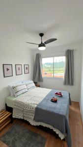 a bedroom with a bed and a ceiling fan at Ponte Laguna, Parque Burle Max in Sao Paulo
