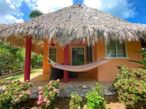 a hammock in front of a small house at Labellaventura in Las Galeras