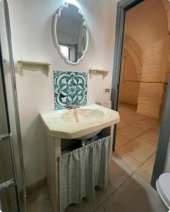 een badkamer met een wastafel en een spiegel bij La Ramasola in Fasano