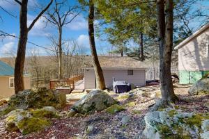 a backyard with rocks and trees and a house at Alpine Dreams in Champion