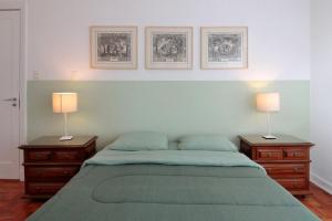 a bedroom with two night stands and a bed with two lamps at Classic SP House in High End Neighborhood in Sao Paulo