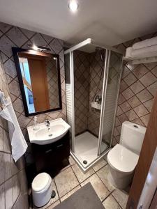 a bathroom with a shower and a toilet and a sink at La Roca Valencia in Valencia