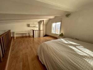 a bedroom with a bed and a wooden floor at La Roca Valencia in Valencia