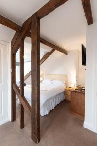 a bedroom with a large bed with wooden beams at Prospect House in Whitby