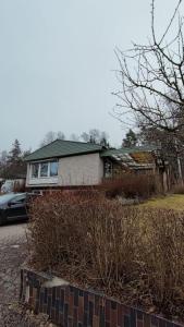 a house with a car parked in front of it at Sollenatuna cozy & spacial apartment in Sollentuna +20 photos